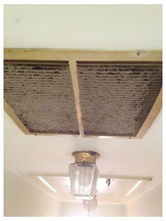 View of dirty return vent in a hallway.